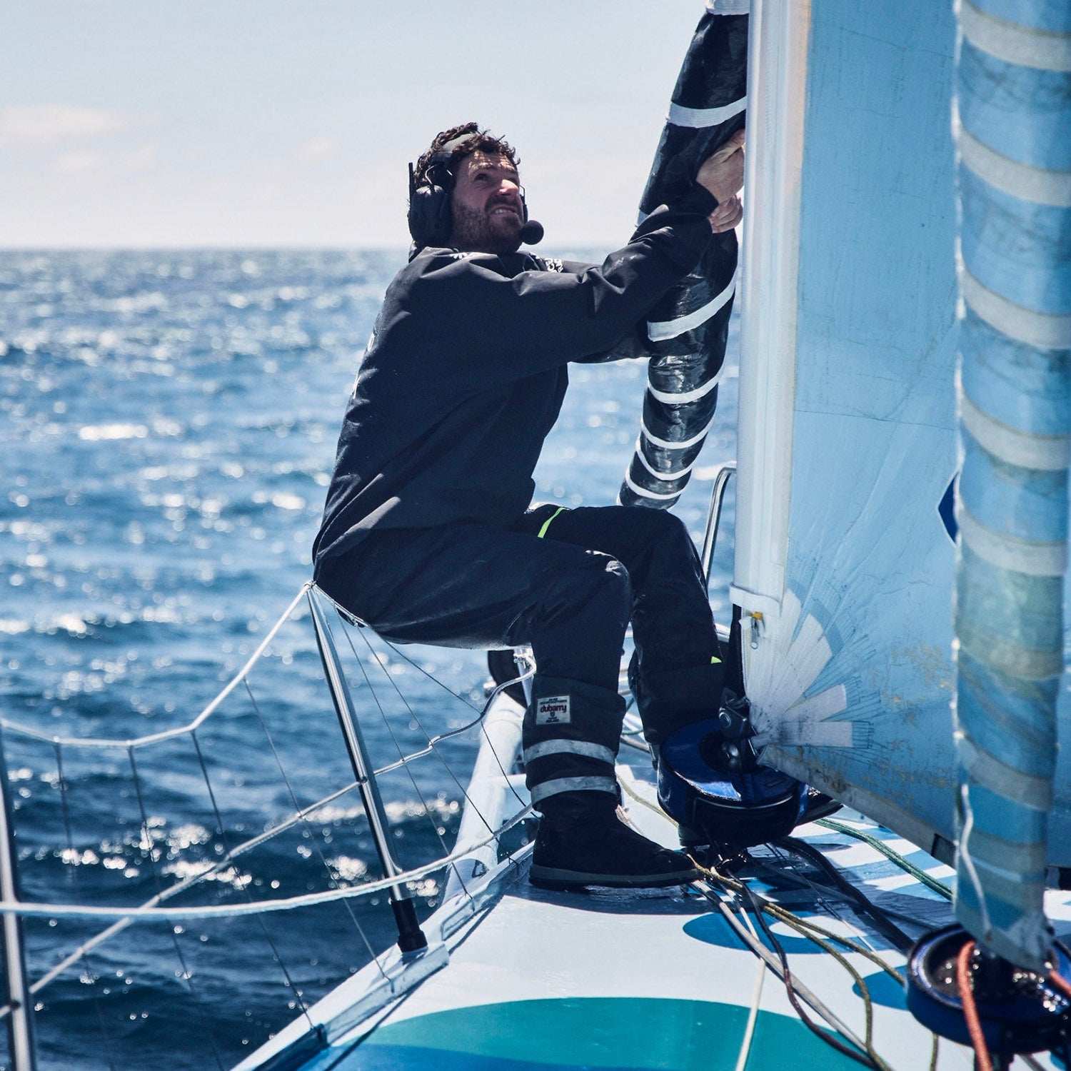 Member of team Holcim - PRB working on the boat during the Ocean Race 2023.//© Team Holcim - PRB | Anne Beauge