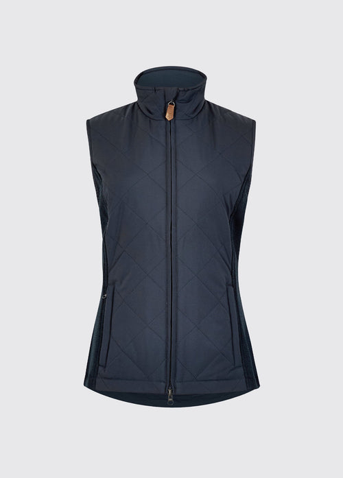 Navy womens quilted vest with a high collar, full zip front, diamond quilting and stretch knit side panels for warmth and comfort